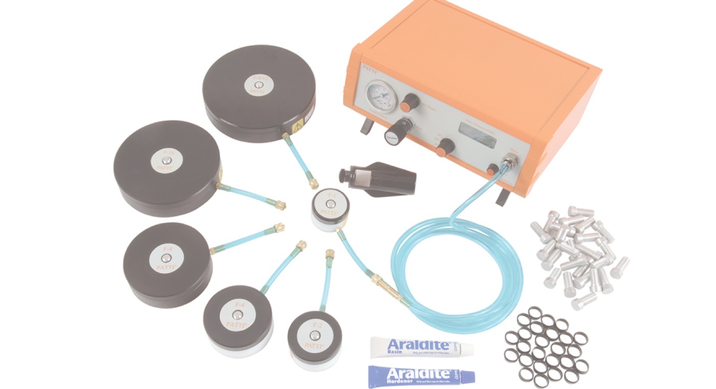 An Elcometer PATTI pneumatic adhesion tester with pull stubs, air line and adhesive