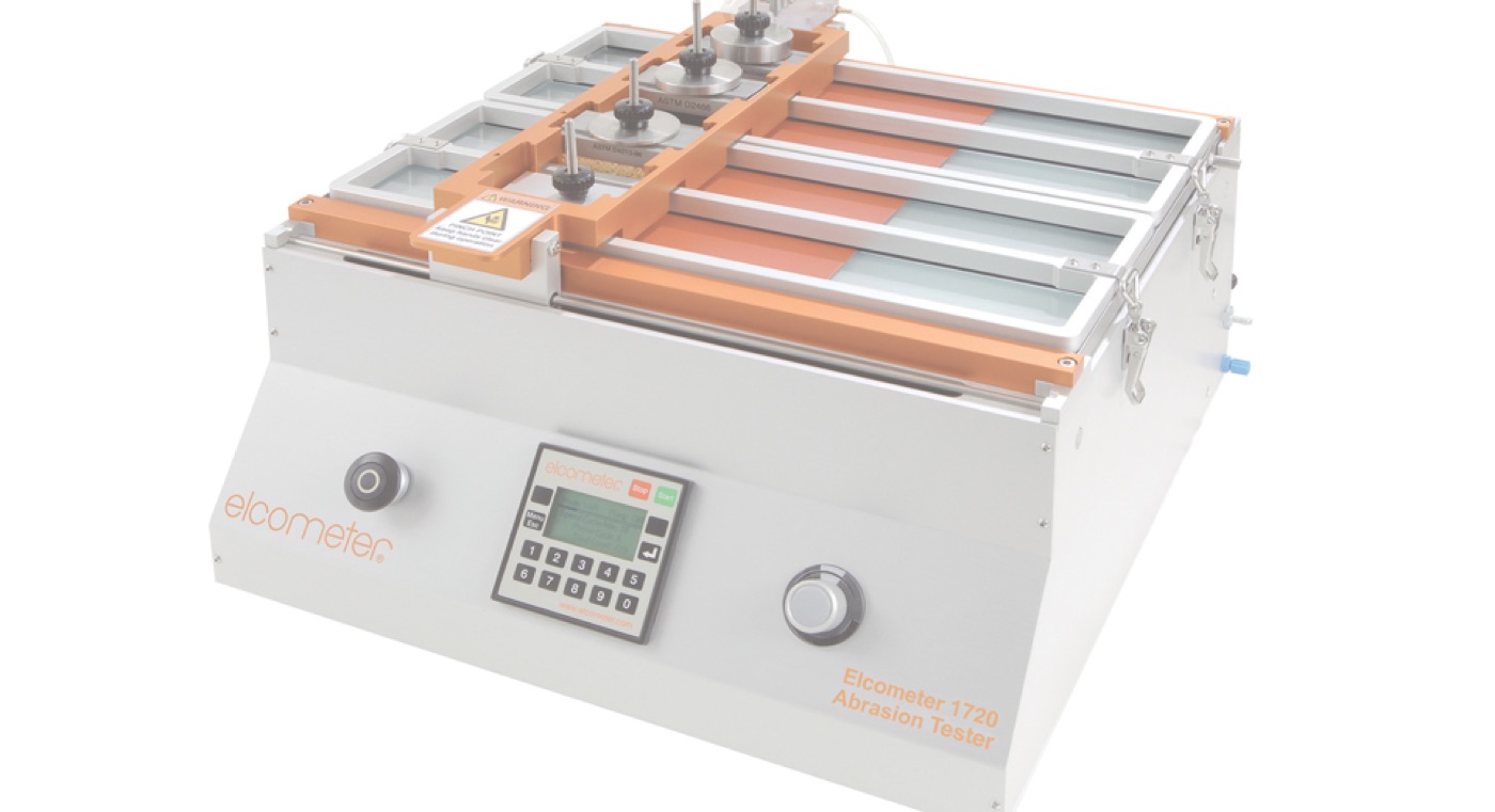 The Elcometer 1720 abrasion tester, a benchtop unit with test trays