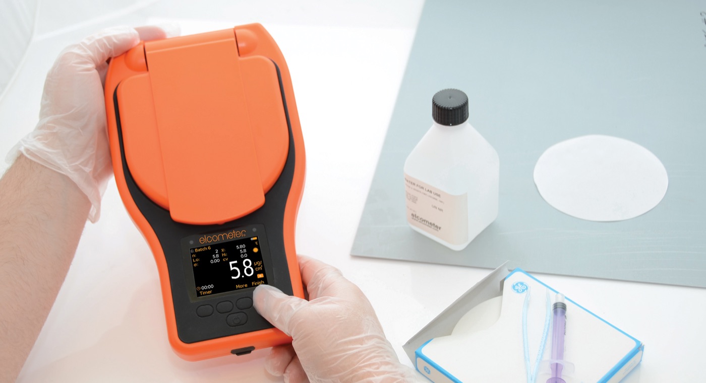 An Elcometer salt contamination meter being used with a Bresle patch in a laboratory