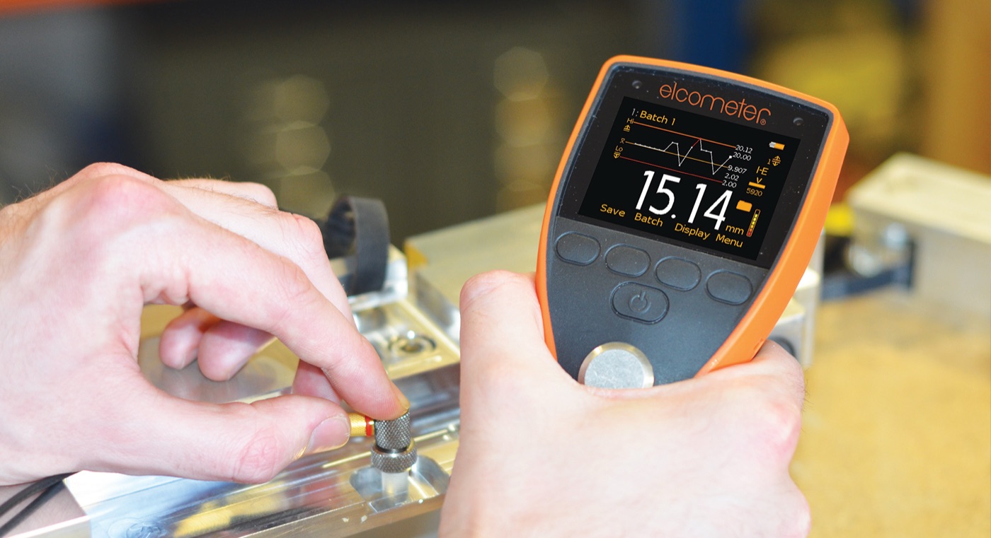An Elcometer precision material thickness gauge reading 15.14mm on a machined metal block