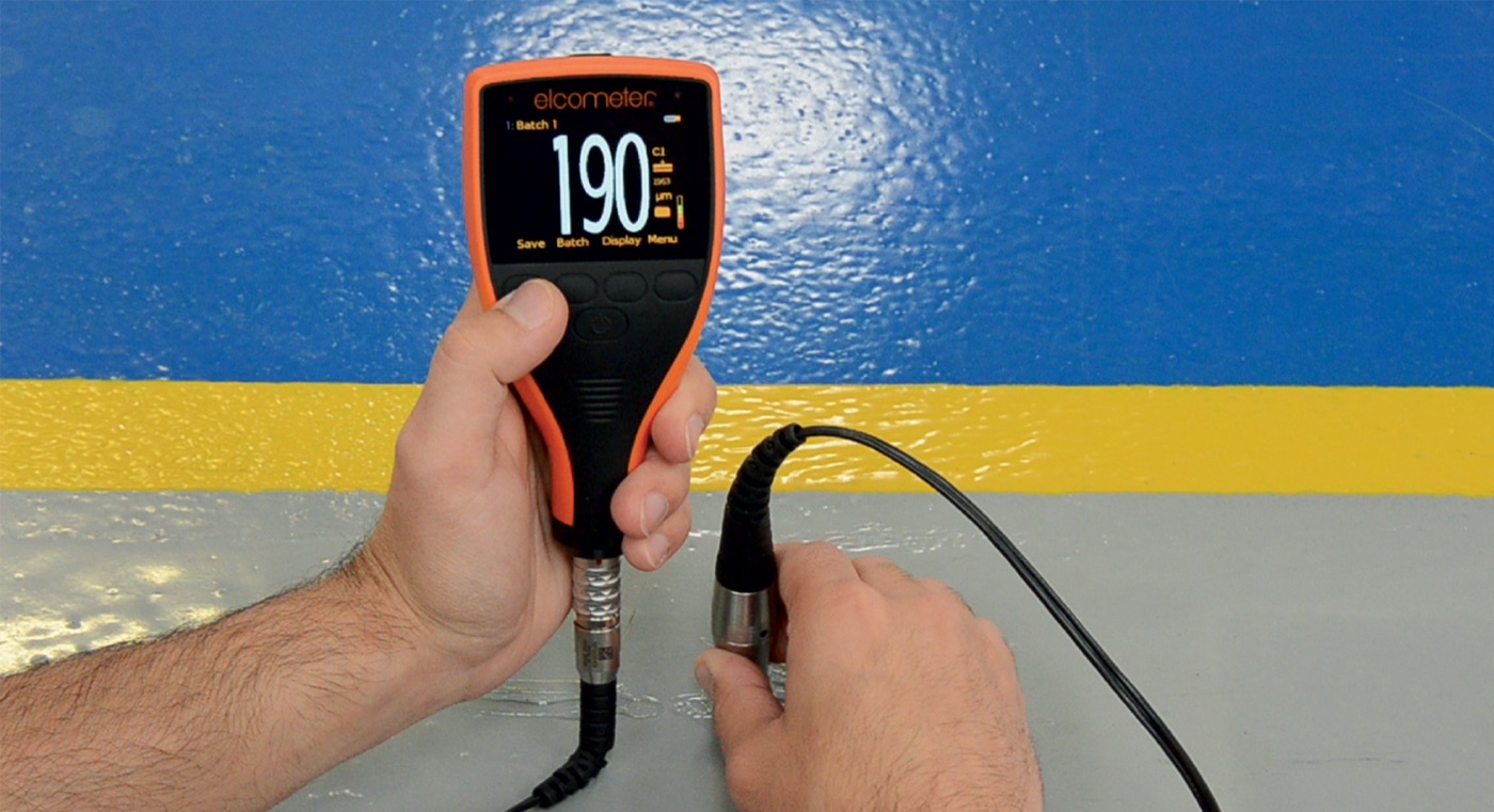 An Elcometer coating thickness gauge measuring 190 microns on a coated wall